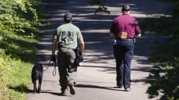 Investigators walk up a blocked off drive way, in, Solebury, Pa., as the search continues Wednesday, July 12, 2017, for four missing young Pennsylvania men feared to be the victims of foul play. (AP Photo/Matt Rourke)