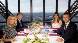 French President Emmanuel Macron (R), his wife Brigitte Macron (L), US President Donald Trump (2nd L) and First Lady Melania Trump (2nd R) attend a dinner at Le Jules Verne Restaurant on the Eiffel Tower in Paris, on July 13, 2017 as part of US president's 24-hour trip that coincides with France's national day and the 100th anniversary of US involvement in World War I. AFP PHOTO / SAUL LOEB     