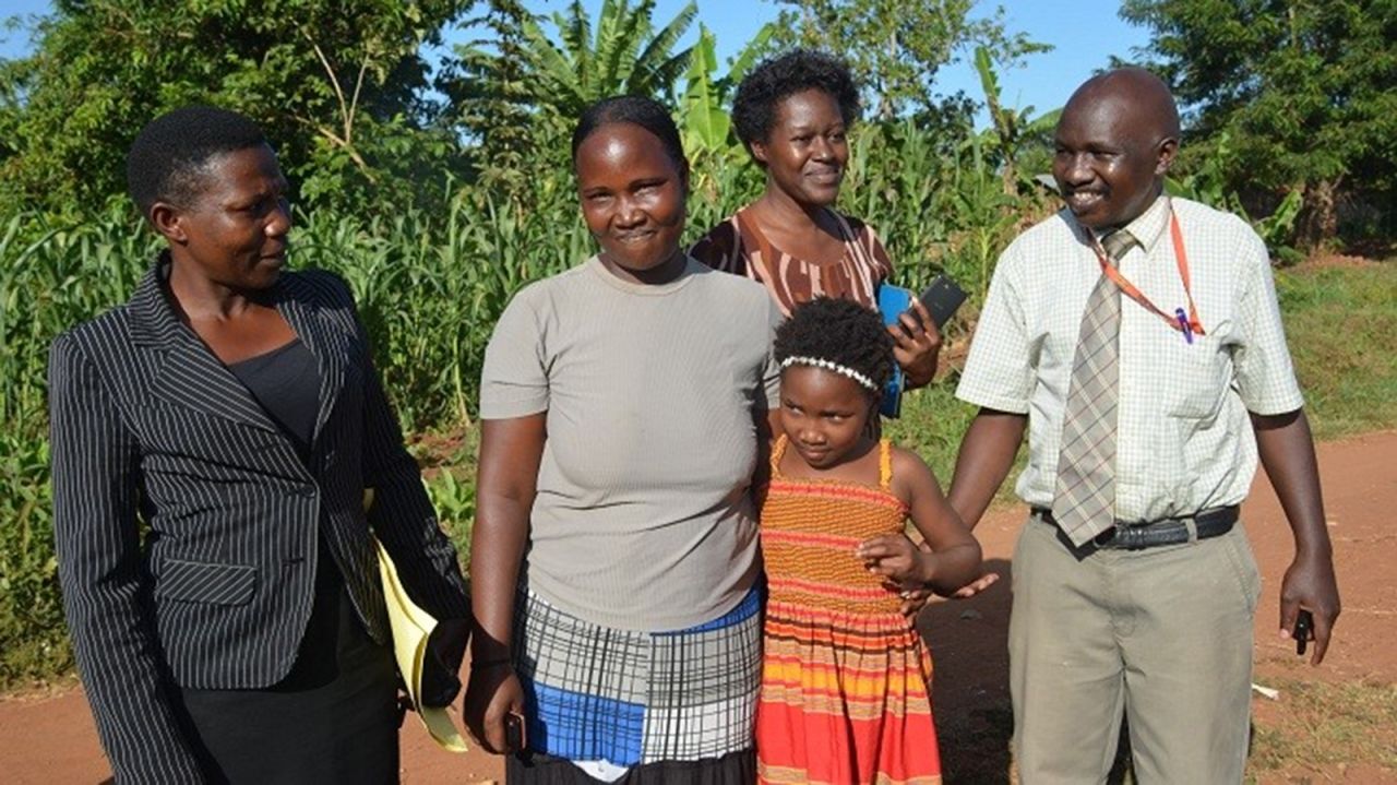 Wells and her husband discovered the truth when they found a Facebook page for Reunite and saw a photo of a woman who claimed that her children had been taken. "We said, 'that's Violah's mother,' " Wells said. "And we were just sick." Here, Ugandan investigators join Violah and her mother (center, in gray shirt) for the reunion.<br />