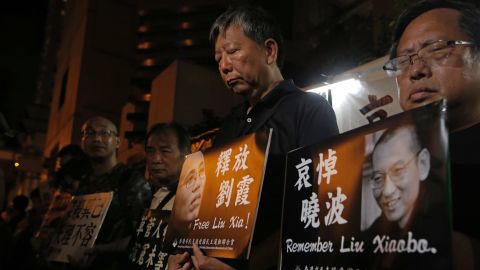 Protesters mourn jailed the death of Chinese Nobel Peace laureate Liu Xiaobo during a demonstration in Hong Kong on 13 July 13.