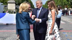US President Donald Trump (2nd R) shakes hands with French President Emmanuel Macron (2nd L) and his wife Brigitte Macron (L), next to US First Lady Melania Trump, during the annual Bastille Day military parade on the Champs-Elysees avenue in Paris on July 14, 2017.
The parade on Paris's Champs-Elysees will commemorate the centenary of the US entering WWI and will feature horses, helicopters, planes and troops. / AFP PHOTO / POOL AND AFP PHOTO / CHRISTOPHE ARCHAMBAULT        (Photo credit should read CHRISTOPHE ARCHAMBAULT/AFP/Getty Images)