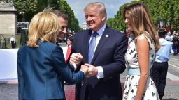 US President Donald Trump shakes hands with French President Emmanuel Macron and his wife Brigitte Macron, next to US First Lady Melania Trump, during the annual Bastille Day military parade on the Champs-Elysees avenue in Paris on July 14.