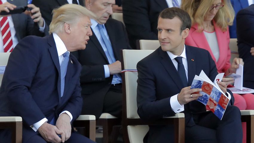 U.S. President Donald Trump, left, discusses with French President Emmanuel Macron prior to the traditional Bastille Day military parade on the Champs Elysees, in Paris, Friday, July 14, 2017. (AP Photo/Michel Euler)