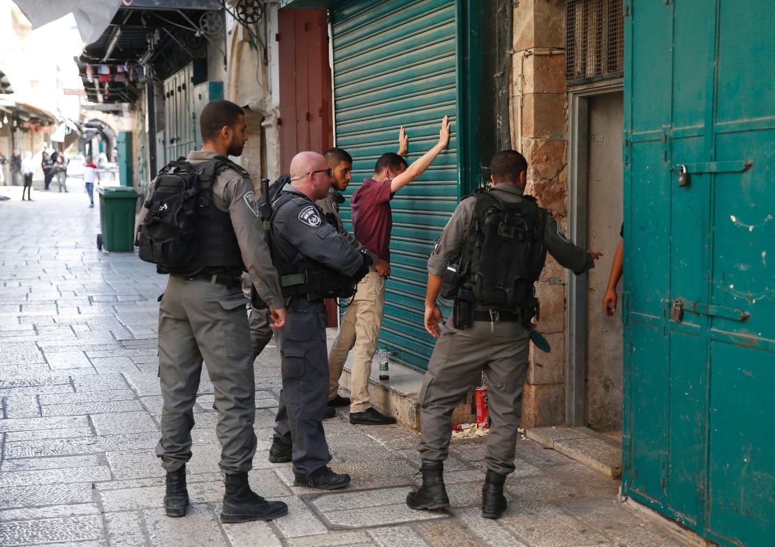 Israeli security forces frisk a Palestinian youth in Jerusalem's Old City following Friday's attack.