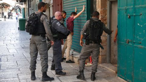 Israeli security forces frisk a Palestinian youth in Jerusalem's Old City following Friday's attack.