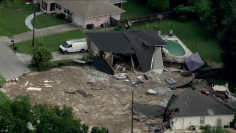 A sinkhole in Land O' Lakes, Florida, swallowed two homes and forced the evacuation of nine others.