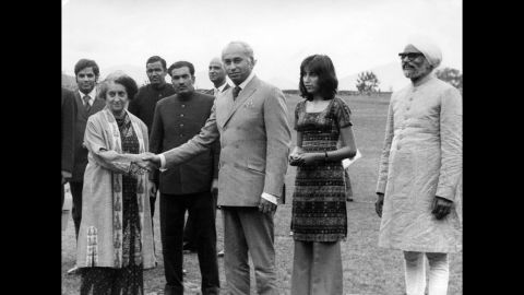 Then-Pakistani President Zulfikar Ali Bhutto (center) shakes hands with then-Indian Prime Minister Indira Gandhi (left). Gandhi succeeded her late father, Nehru, who passed away on May 27, 1964. Bhutto's daughter, Benazir (second right), and former Indian Foreign Minister Swaran Singh (right) look on in Shimla, a city in the Himalayan foothills of India on June, 28, 1972.<br /><br />The visit took place after a war broke out between the two nations in 1971, that led to the creation of Bangladesh, formerly known as East Pakistan. Bhutto visited India to meet Gandhi and negotiated a formal peace agreement. The two leaders signed the Shimla Agreement, which committed both nations to establish a Line of Control in Kashmir and obligated them to resolve disputes peacefully through bilateral talks.<br />Three more wars later, the last fought in 1999, peace is yet to be established.