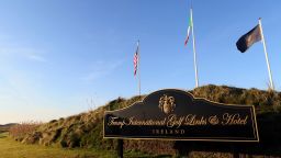 Flags fly outside the entrance to Trump International Golf Course, owned by US President-elect Donald Trump, near Doonbeg, on the west coast of Ireland, on December 2, 2016.
Even in Doonbeg, however, the tenure of US President-elect Donald Trump has created tensions, mainly over a proposed 2.8-kilometre long, 4.5-metre high coastal wall the public beach adjoining his property to protect the golf course from winter storms. / AFP / PAUL FAITH / TO GO WITH AFP STORY by Douglas Dalby        (Photo credit should read PAUL FAITH/AFP/Getty Images)