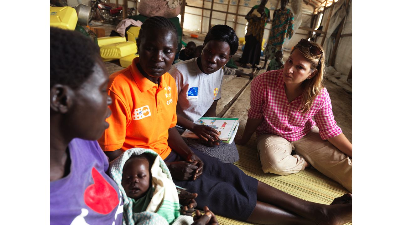 Heather Higginbottom sits with Esther, a refugee from South Sudan, who arrived in Uganda with her 3-week-old newborn.