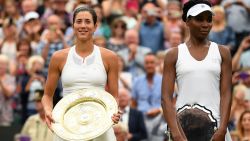 LONDON, ENGLAND - JULY 15:  Garbine Muguruza of Spain celebrates victory with the trophy alongside runner up Venus Williams of The United States after the Ladies Singles final on day twelve of the Wimbledon Lawn Tennis Championships at the All England Lawn Tennis and Croquet Club at Wimbledon on July 15, 2017 in London, England.  (Photo by David Ramos/Getty Images)