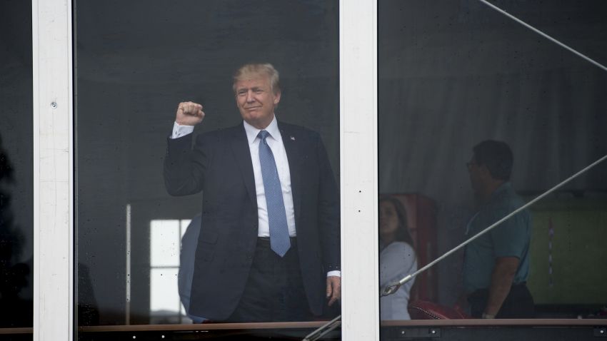 US President Donald Trump waves to wellwishers as he arrives at the 72nd US Women's Open Golf Championship at Trump National in Bedminister, New Jersey, July 14, 2017. / AFP PHOTO / SAUL LOEB        (Photo credit should read SAUL LOEB/AFP/Getty Images)