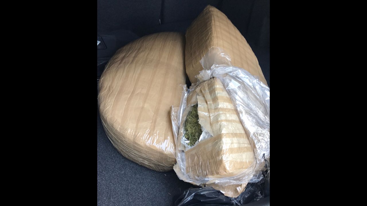 The marijuana was tightly packed in the shape of half-moons and hidden in the cars' spare tire wheel wells.