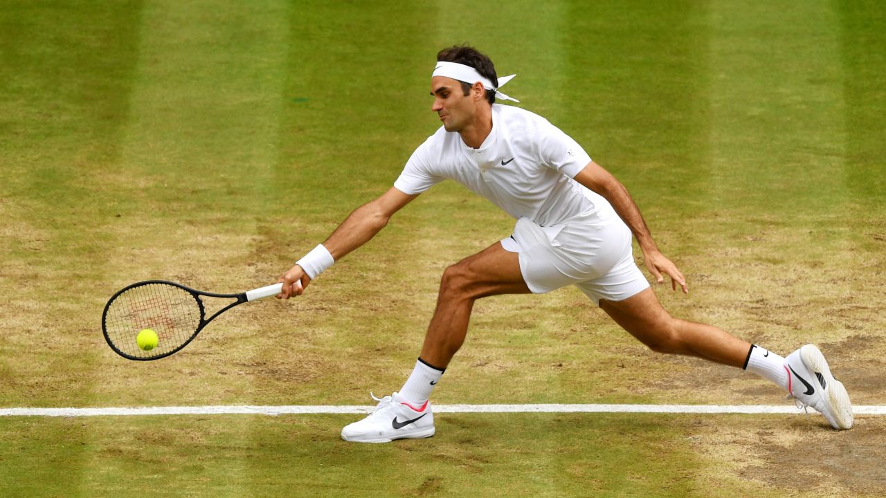 Federer stretches to play a forehand.