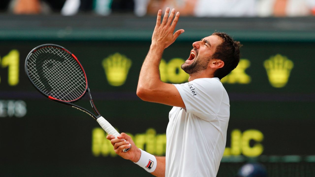 Cilic reacts after hitting the ball into the net.
