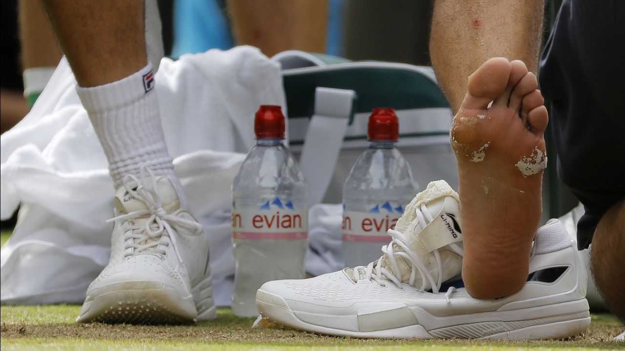 Cilic receives treatment to his foot during a medical timeout.