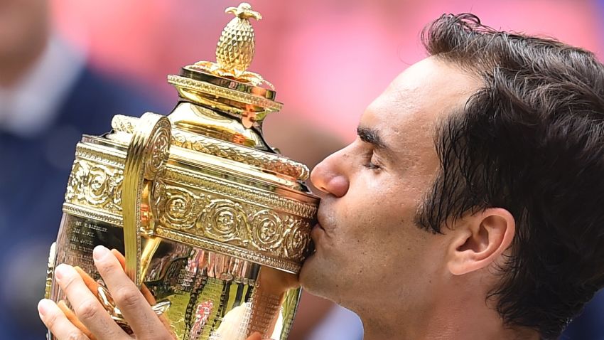 Switzerland's Roger Federer kisses the winner's trophy after beating Croatia's Marin Cilic in their men's singles final match, during the presentation on the last day of the 2017 Wimbledon Championships at The All England Lawn Tennis Club in Wimbledon, southwest London, on July 16, 2017. Federer won 6-3, 6-1, 6-4.