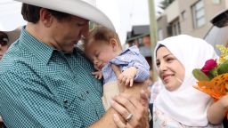 Canadian Prime Minister Justin Trudeau holds his name sake Justin-Trudeau Adam Bilal while attending the Calgary Stampede on Saturday, July 15. The parents of the mini-Trudeau, Afraa Hajj Hammoud and Mohammed Belal, left Syria six years ago and settled in Canada in 2016.