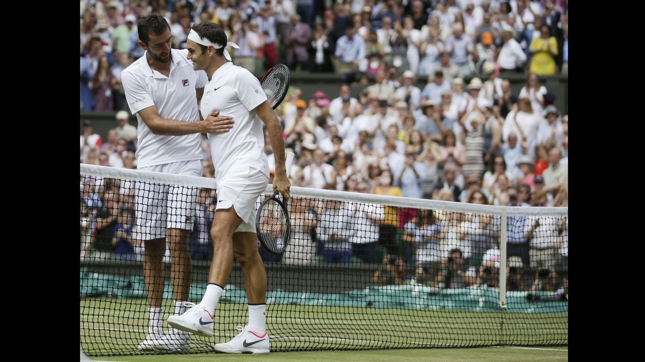 Marin Cilic congratulates Federer at the net after their match. 