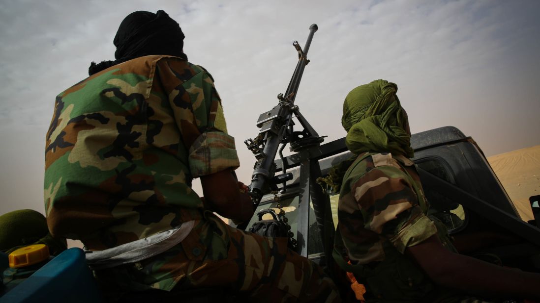 Soldiers escort the rescued migrants back to Agadez. No one knows just how many migrants are perishing in the desert, but the IOM says its joint operations with the military have saved 600 lives since April.