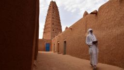 A man walks in the vicinity of a earthen mud mosque in Agadez, in northern Niger, on April 2, 2017.  / AFP PHOTO / ISSOUF SANOGO        (Photo credit should read ISSOUF SANOGO/AFP/Getty Images)