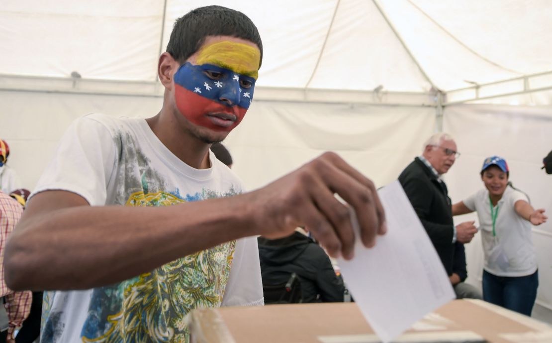 A Venezuelan residing in Colombia casts his vote during the symbolic vote.