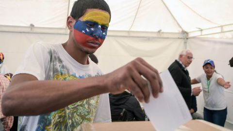 A Venezuelan residing in Colombia casts his vote during the symbolic vote.