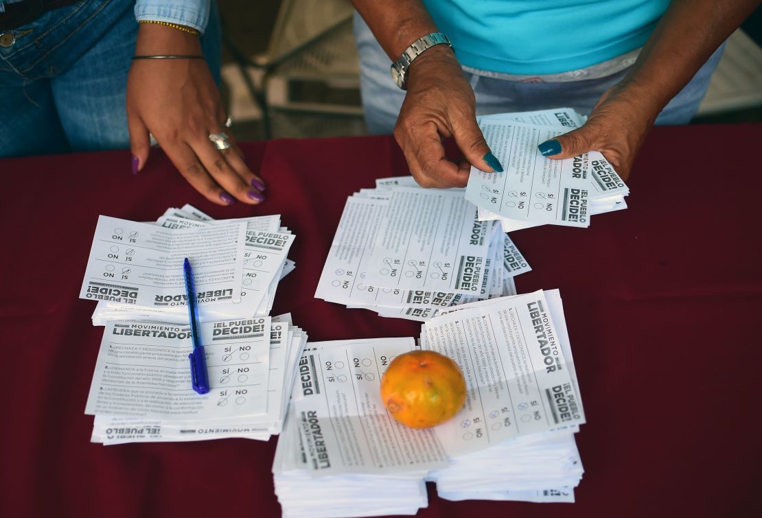 Volunteers count the ballots during an opposition-organized vote to measure public support for Venezuelan President Nicolas Maduro's plan to rewrite the constitution.