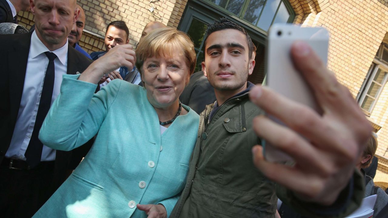 Merkel poses for a selfie with a Syrian refugee at a shelter in Berlin in September 2015. 