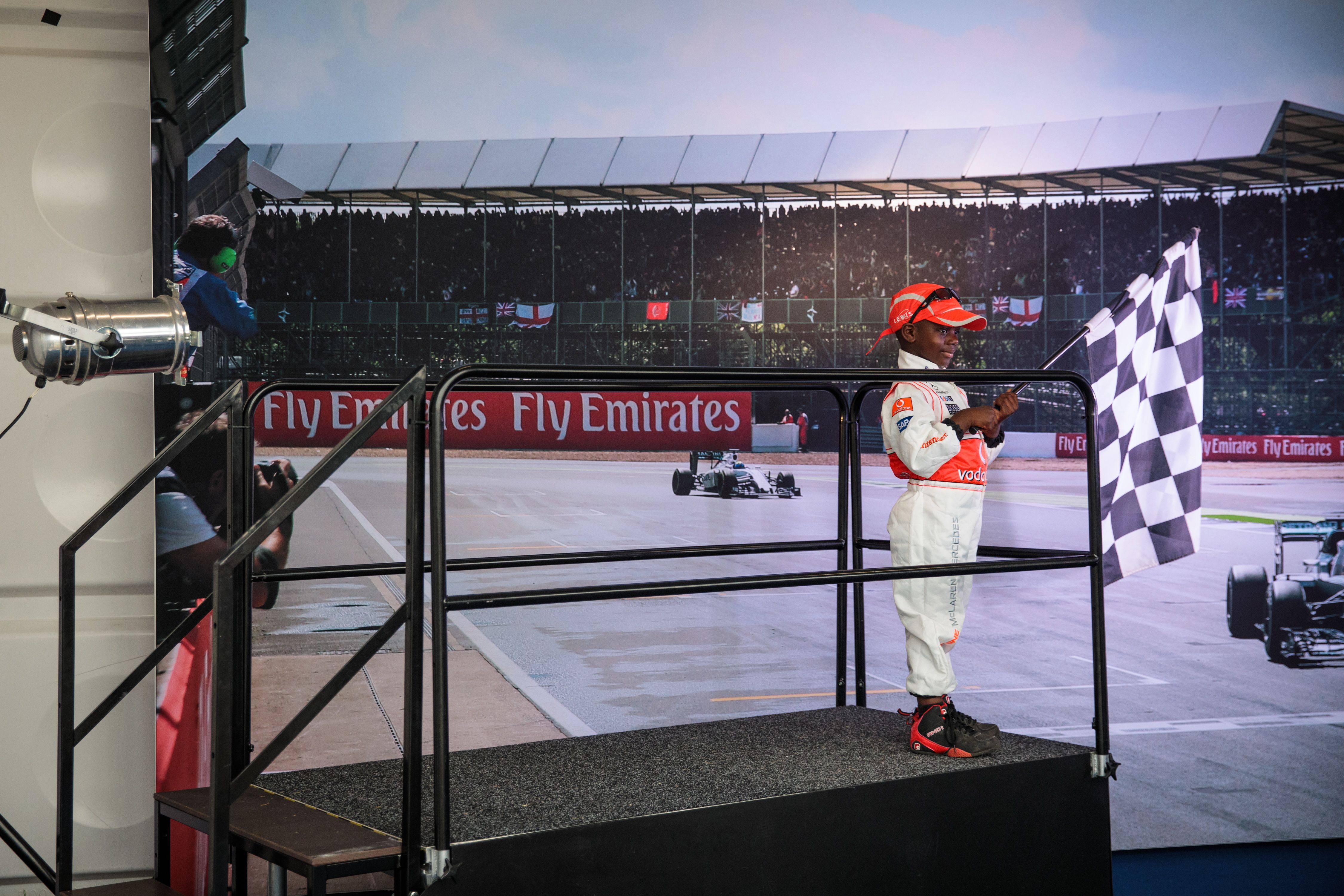 A young motorsport enthusiast enjoys one of the features at the Silverstone fan zone at this year's Grand Prix. 