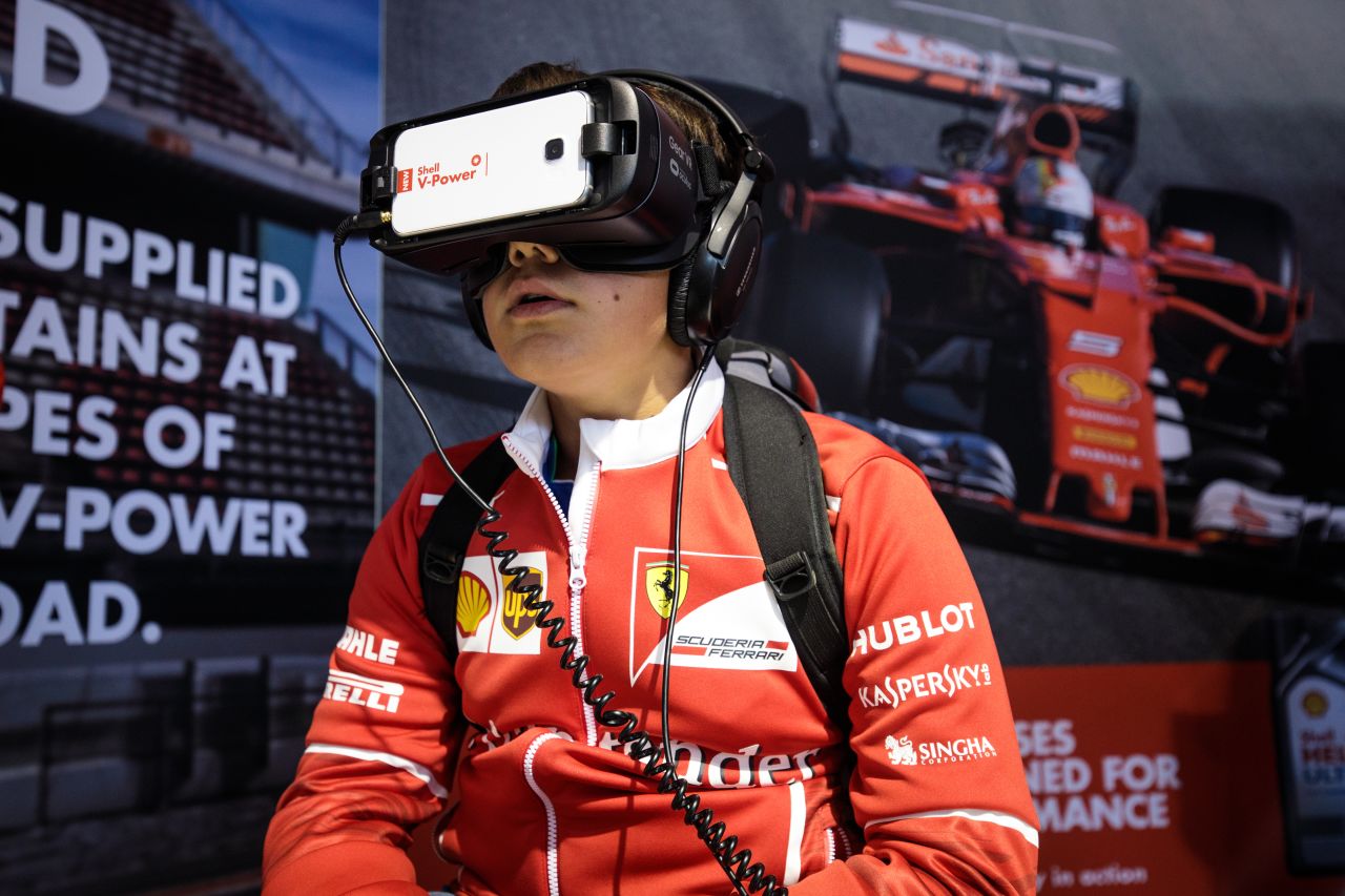 A young fan uses a virtual reality headset in the fan zone at Silverstone. F1's new owners have been revamping the attractions at race venues this season.  