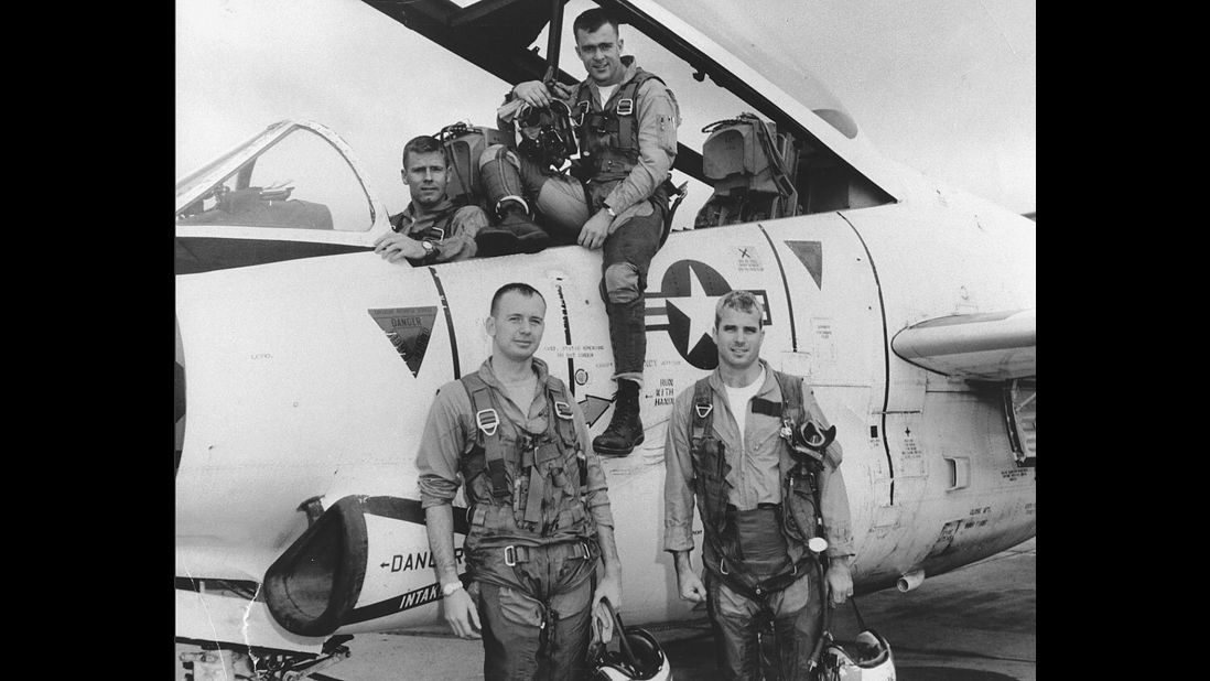 McCain, bottom right, poses with his Navy squadron in 1965.