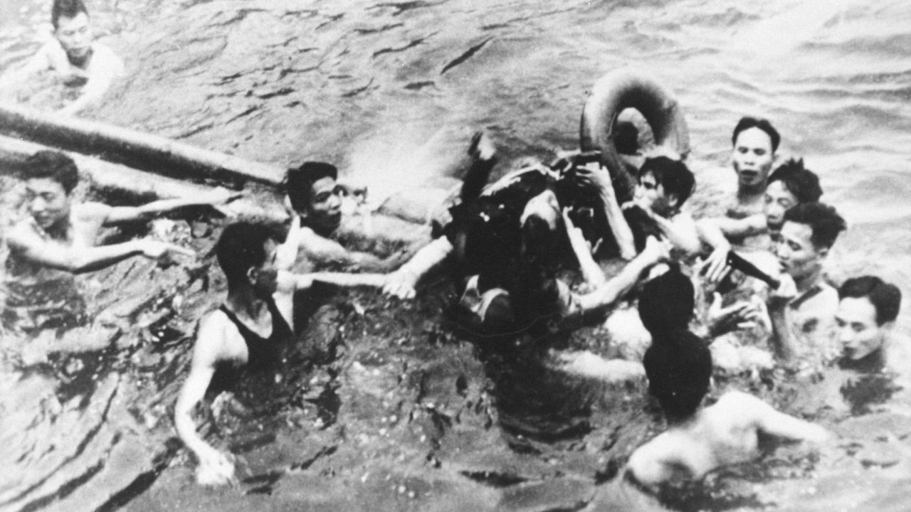 During the Vietnam War, McCain's plane was shot down and captured by North Vietnamese forces. Here, he is pulled out of a lake in Hanoi by North Vietnamese soldiers and civilians in October 1967. McCain broke both arms and his right knee upon ejection and lost consciousness until he hit the water. Upon capture, McCain was beaten, he has said. He was held for five years by the North Vietnamese and tortured.