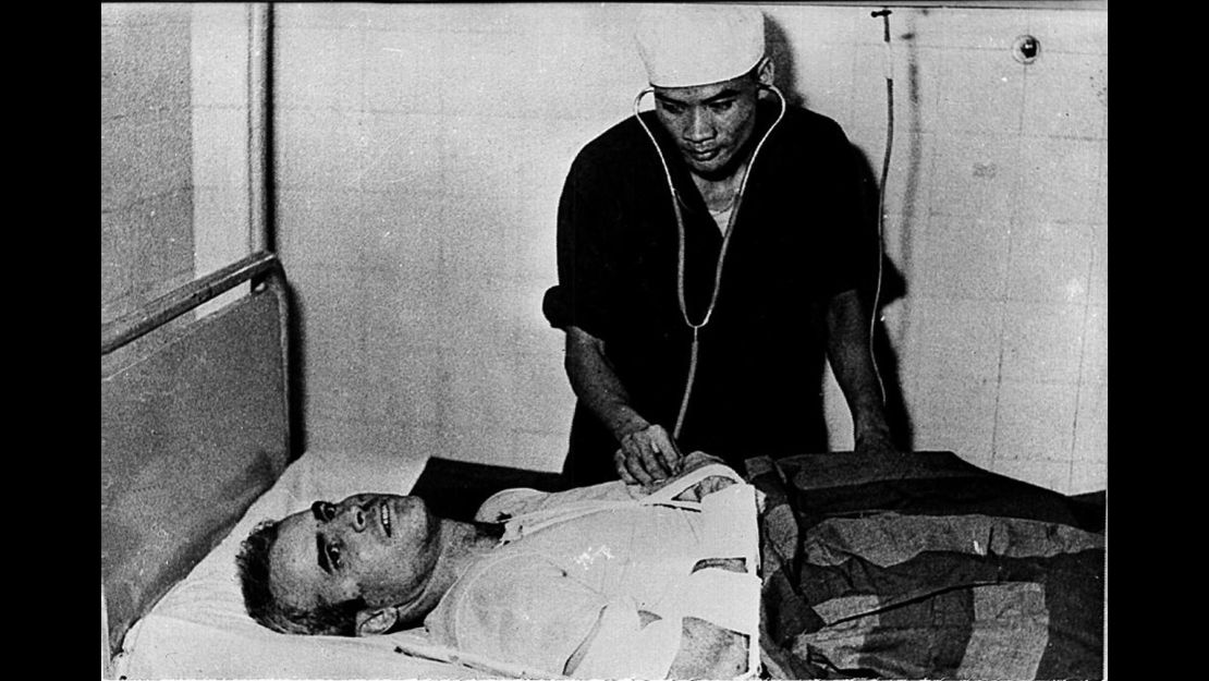 John McCain is examined by a Vietnamese doctor in 1967 after being captured in Hanoi.