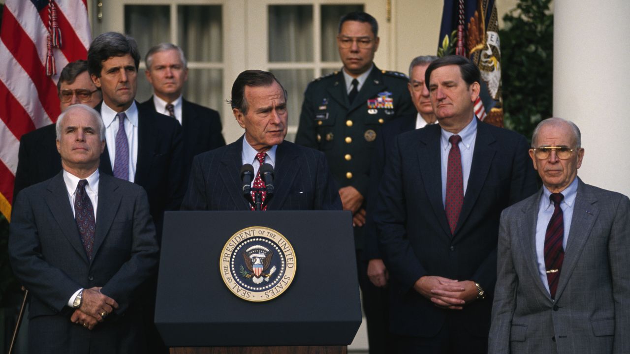 McCain, left, joins President George H.W. Bush at a news conference about soldiers missing in action during the Vietnam War.