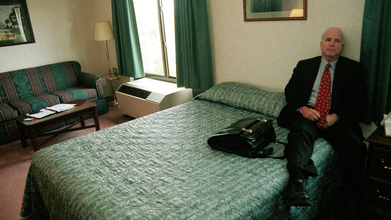 McCain rests in a New Hampshire motel room while on the campaign trail in 1999.