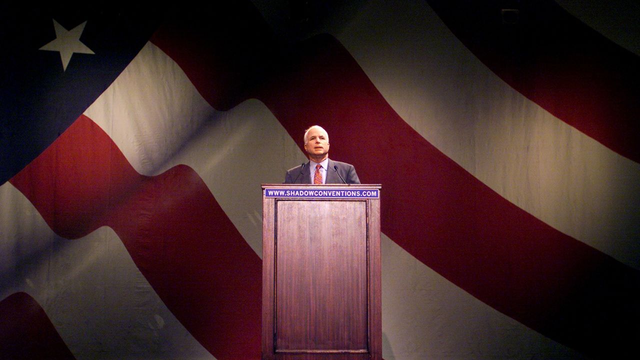 John McCain addresses a shadow convention at the University of Pennsylvania in 2000. McCain was booed when he asked supporters to back George W. Bush for President.