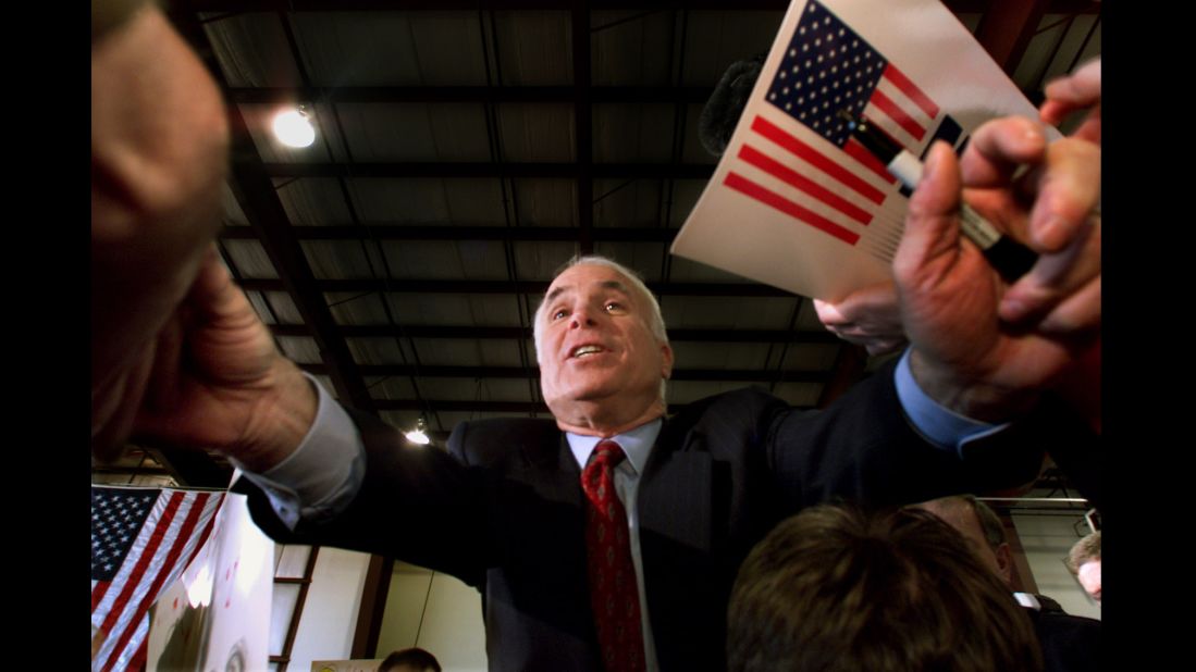 McCain reaches out to supporters during a campaign rally in Portland, Maine, in 2000. He suspended his campaign several days later and eventually endorsed his primary opponent, George W. Bush.
