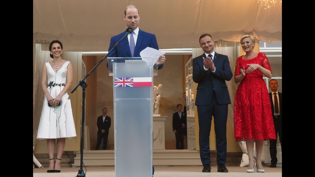 William speaks as Kate, left, and Polish President Andrzej Duda and his wife, Agata Kornhauser-Duda, listen during a Queen's birthday party on July 17, in the Orangery in Lazienki Park in Warsaw, Poland.