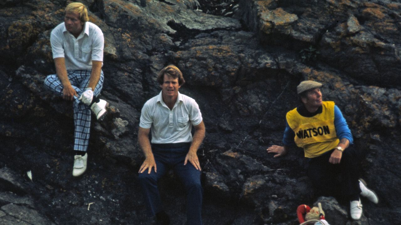A famous photograph of Nicklaus, Watson and their caddies sitting on a rock as a storm passed over during the third round