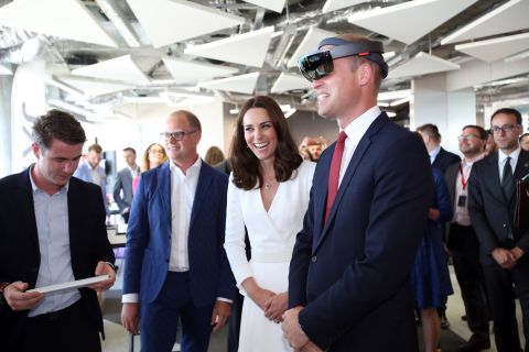 William wears virtual-reality goggles as Kate laughs during a meeting with young Polish entrepreneurs in Warsaw, Poland.