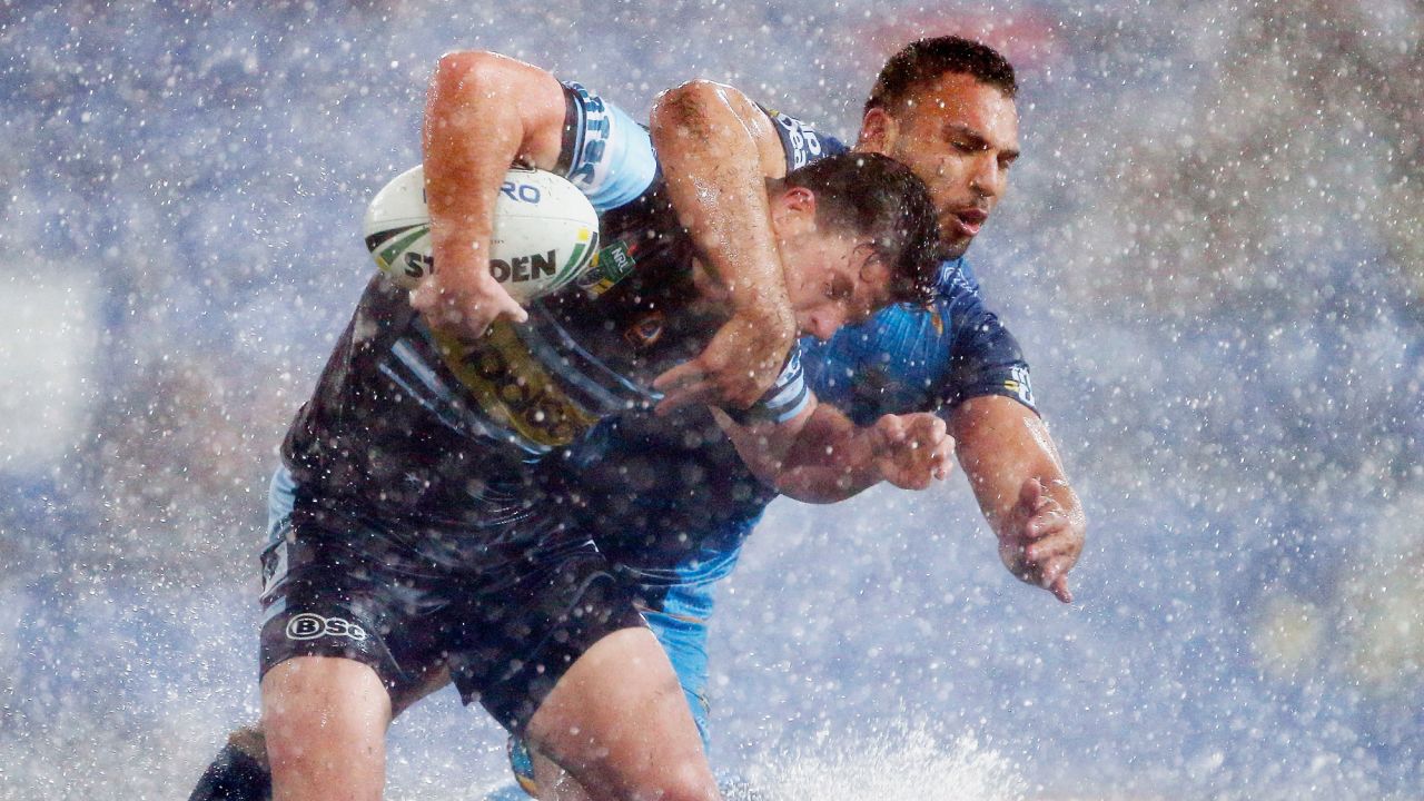 Chad Townsend of the Sharks, left, is tackled by Ryan James of the Titans during an NRL match between the Gold Coast Titans and the Cronulla Sharks on Saturday, July 15, in Gold Coast, Australia.