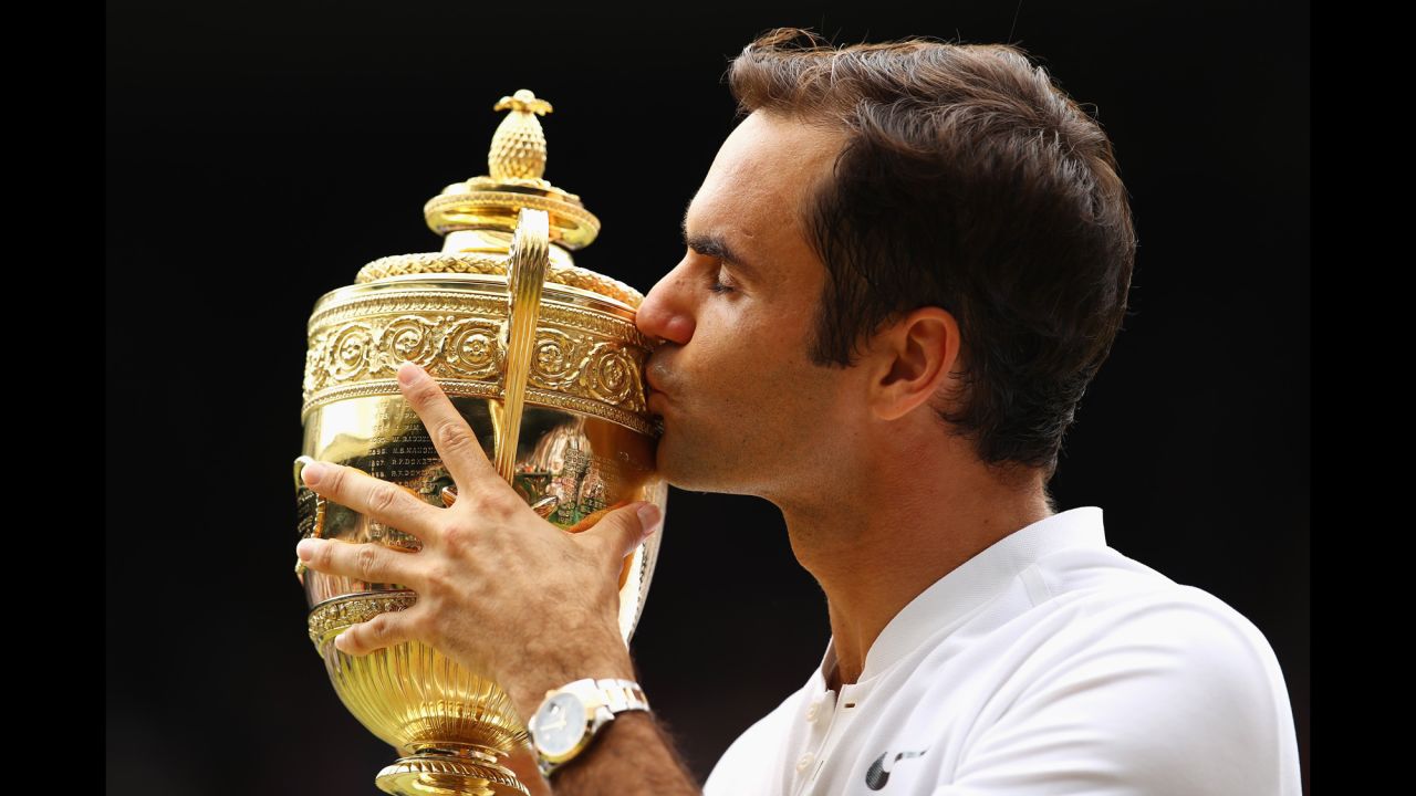 Roger Federer of Switzerland <a href="http://www.cnn.com/2017/07/16/sport/gallery/wimbledon-mens-2017/index.html" target="_blank">kisses his trophy</a> as he celebrates after <a href="http://edition.cnn.com/2017/07/17/sport/federer-wimbledon-us-open-grand-slam-twenty/index.html" target="_blank">winning the Gentlemen's Singles final </a>against Marin Cilic of Croatia at the Wimbledon Lawn Tennis Championships on Sunday, July 16, in London.
