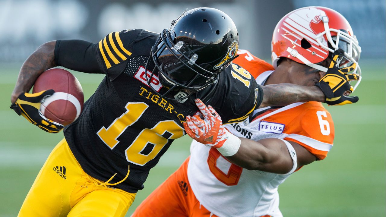 Hamilton Tiger-Cats' Brandon Banks, left, pushes off BC Lions defensive back T.J. Lee during a Canadian Football League game in Ontario on Saturday, July 15.