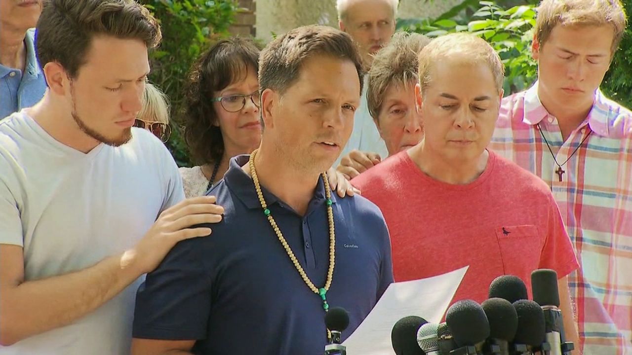 Don Damond, middle, mourns the loss of his fiancee, Justine Ruszczyk.