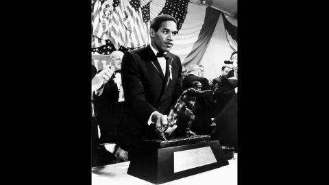 As a University of Southern California running back, Simpson accepts the Heisman Trophy in December 1968.