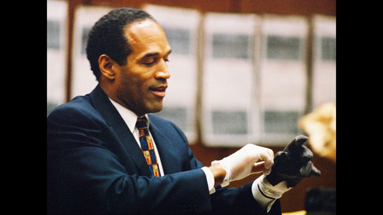 <a href="http://www.cnn.com/US/OJ/daily/9-27/8pm/">"If it doesn't fit, you must acquit" </a>was defense attorney Cochran's mantra during the trial. Here, Simpson tries on a leather glove tied to the crime scene at his murder trial on June 15, 1995.