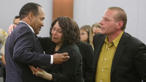 Simpson embraces his sister, Carmelita Durio, while his friend Tom Scotto looks on in court after a guilty verdict was reached in October 2008. Simpson was convicted of leading a group of associates into a room at the Palace Station Hotel and Casino and using threats, guns and force to take back items from two dealers.