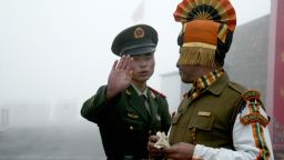 In this photograph taken on July 10, 2008, A Chinese soldier gestures as he stands near an Indian soldier on the Chinese side of the ancient Nathu La border crossing between India and China. AFP PHOTO/Diptendu DUTTA/Getty Images