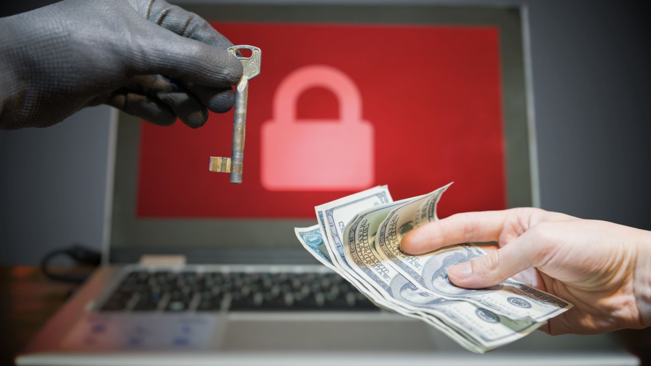 Computer security and hacking concept. Ransomware virus has encrypted data in laptop. Hacker is offering key to unlock encrypted data for money.