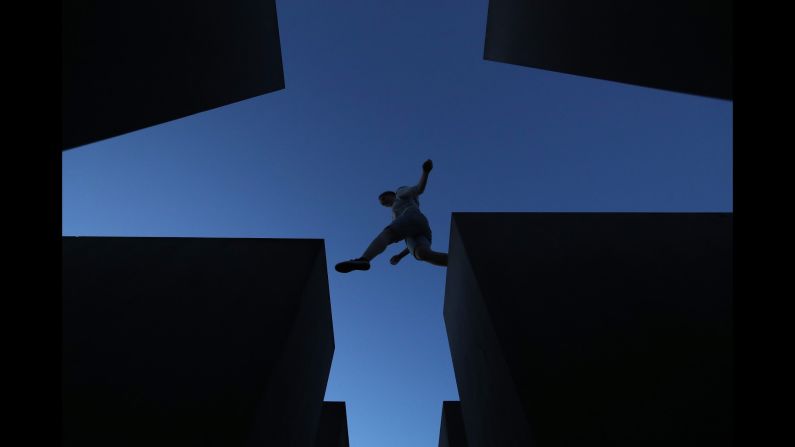 <strong>Berlin:</strong> A visitor leaps across some of the 2,711 concrete blocks that make up Berlin's Holocaust Memorial, designed by architect Peter Eisenman and engineer Buro Happold.